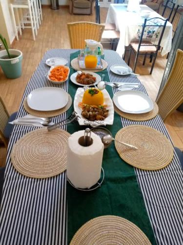 a green and white table with food on it at La Mboroise in Mboro