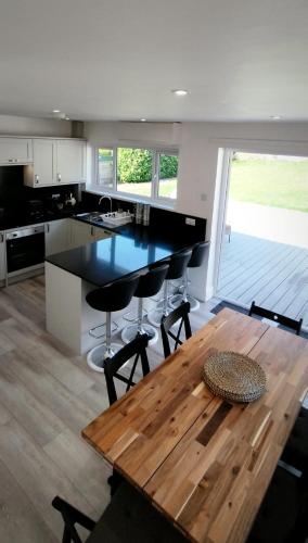 a kitchen with a wooden table and a counter top at Taunton Retreat in Wilton