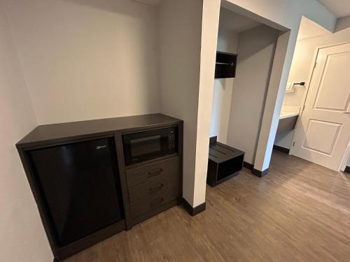 a room with a flat screen tv and a door at Studio 6 Suites Gardena, CA in Gardena