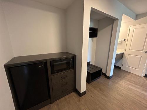 a living room with a flat screen tv in a room at Studio 6 Suites Gardena, CA in Gardena