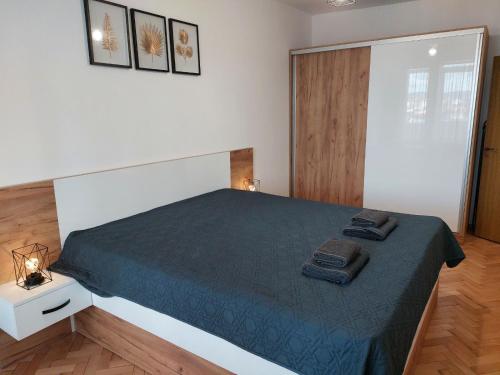a bedroom with a bed with two towels on it at Riverview apartment in Lovech