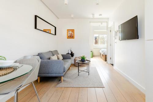 a living room with a couch and a table at Soho by Excel Apartments in London
