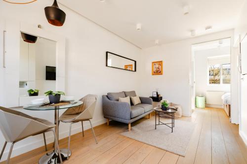 a living room with a couch and a table at Soho by Excel Apartments in London