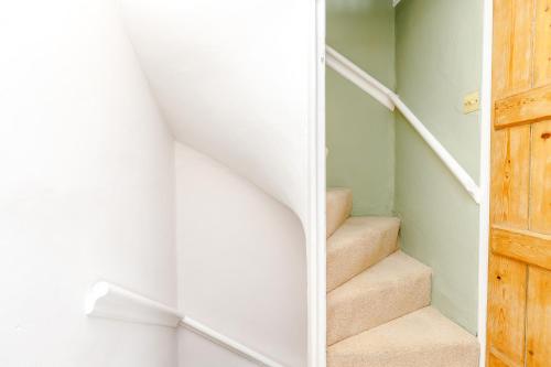 a staircase in a house with a door at 3 Canalside Cottages in Towcester