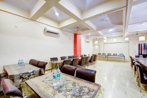 a conference room with tables and chairs and a white wall at Hotel City Centre Inn Near Nizamuddin Railway Station in New Delhi