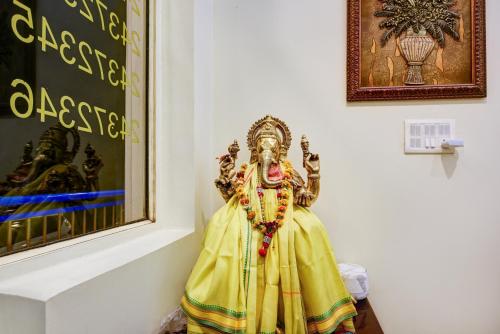 a statue of a deity sitting in a room at Hotel City Centre Inn Near Nizamuddin Railway Station in New Delhi