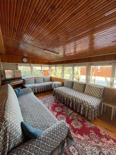 a large living room with couches and a television at Demre Lukka Bungalow in Demre