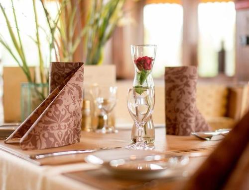 a rose in a glass vase on a table at Haven Hotels - Bochum in Bochum