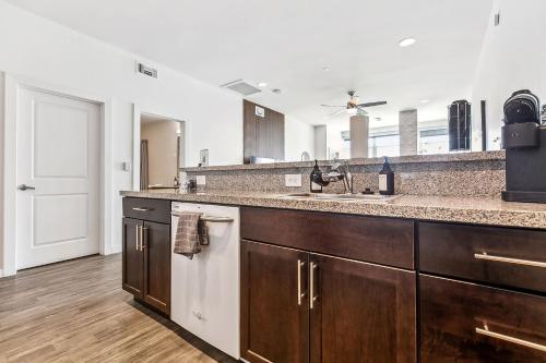 a kitchen with a sink and a counter top at Entire High-Rise Apartment - 2BD in Baton Rouge