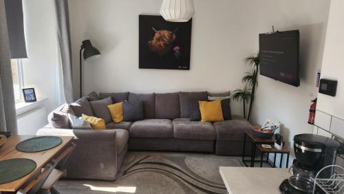 a living room with a couch and a table at Jaymar in Fife