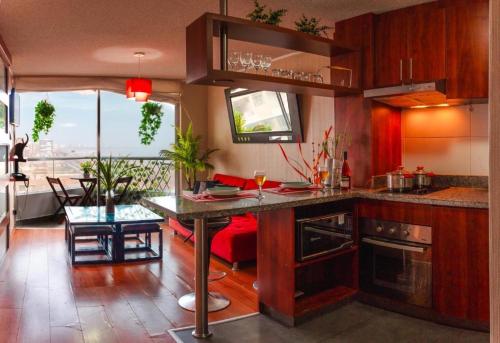 a kitchen with a counter and a table in a room at Panoramic Elegante departamento in Lima