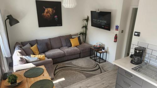 a living room with a couch and a table at Jaymar in Fife