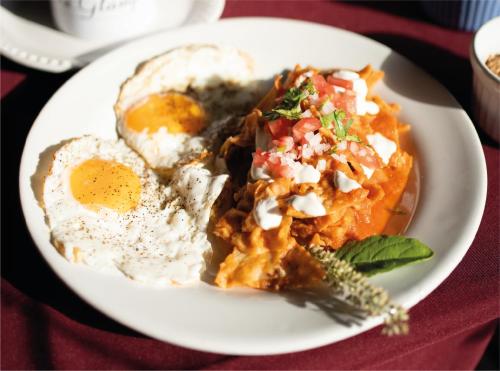 a plate of breakfast food on a red table at Akumal Natura Glamping in Akumal