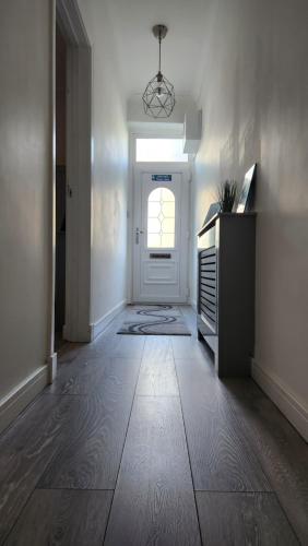 a room with a hallway with a door and a window at Jaymar in Fife