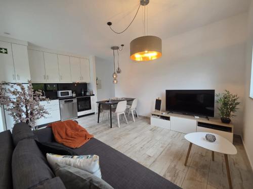 a living room with a couch and a table at Casa Fraga do Suadouro in Campo do Gerês