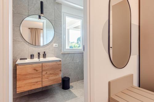 a bathroom with a sink and a mirror at - NumberZ - Rooms Apartments and Suites with Wi-Fi and AC in Borgo Isonzo