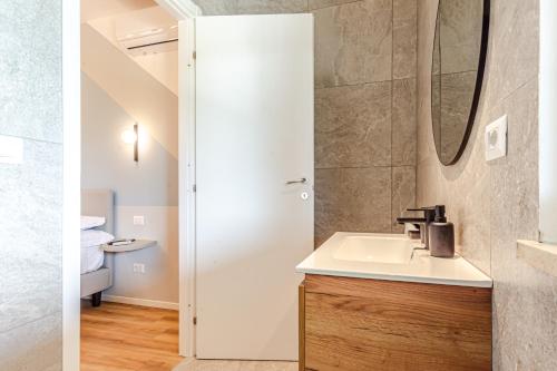 a bathroom with a sink and a mirror at - NumberZ - Rooms Apartments and Suites with Wi-Fi and AC in Borgo Isonzo