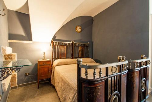 a bedroom with a bed and a table in a room at Studio Raguso in Martina Franca