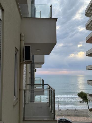 a balcony of a building with a view of the ocean at Deluxe Apartments Shengjin in Shëngjin