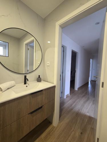 a bathroom with a sink and a mirror at Casa Aurora in Campo do Gerês