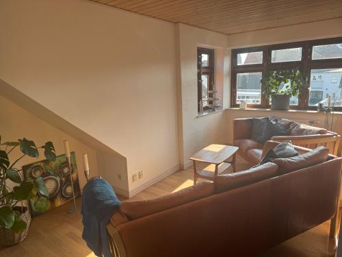 a living room with a couch and a table at Svane's Air-bnb in Nykøbing Mors