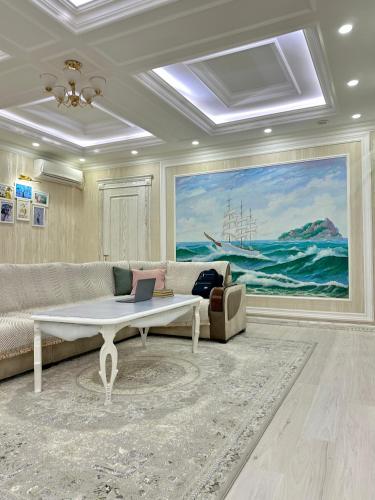 a living room with a couch and a table at Nordic Style Apartment in Fergana