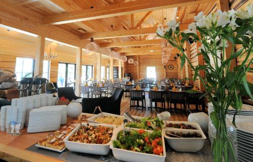 a buffet of food on a table in a restaurant at Hotel Krapi in Tuusula