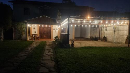 a house with lights on the front of it at night at Casa de Campo La Gloria Ataco in Concepción de Ataco