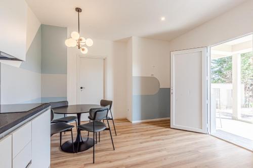 a kitchen and dining room with a table and chairs at - NumberZ - Rooms Apartments and Suites with Wi-Fi and AC in Borgo Isonzo