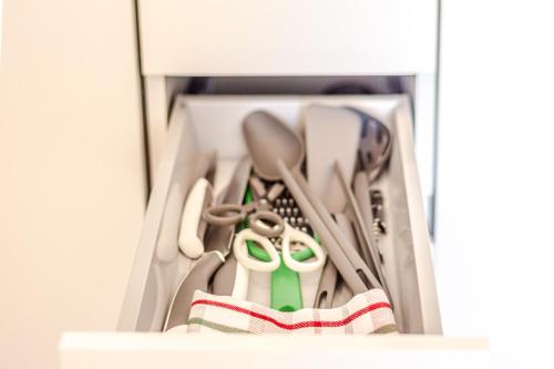 a drawer filled with lots of utensils at - NumberZ - Rooms Apartments and Suites with Wi-Fi and AC in Borgo Isonzo