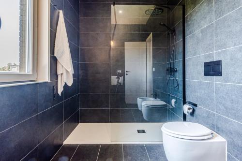 a bathroom with a shower with a toilet and a sink at - NumberZ - Rooms Apartments and Suites with Wi-Fi and AC in Borgo Isonzo