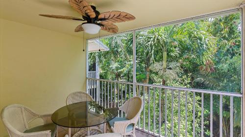 a dining room with a glass table and a large window at Its a Shore Thing in Longboat Key
