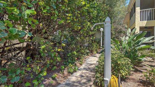 a garden path with a street light next to a tree at Its a Shore Thing in Longboat Key