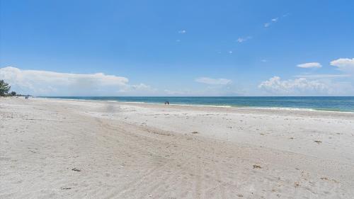 a sandy beach with the ocean in the background at Its a Shore Thing in Longboat Key