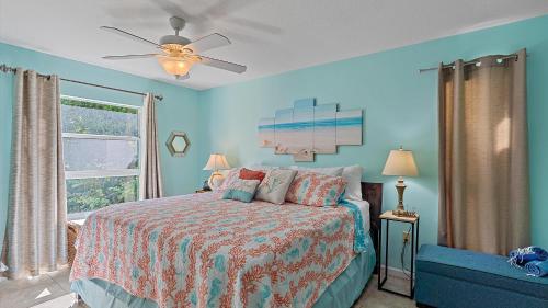 a bedroom with a bed and a ceiling fan at Its a Shore Thing in Longboat Key