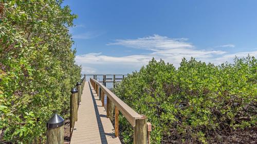 a wooden boardwalk leading to the ocean on a beach at Its a Shore Thing in Longboat Key