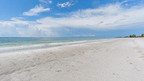 an empty beach with the ocean in the background at Its a Shore Thing in Longboat Key