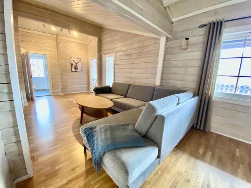 a living room with a couch and a table at Stryn - Faleide - Cabin Fjord view in Stryn