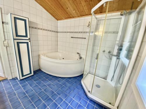 a bathroom with a tub and a glass shower at Stryn - Faleide - Cabin Fjord view in Stryn