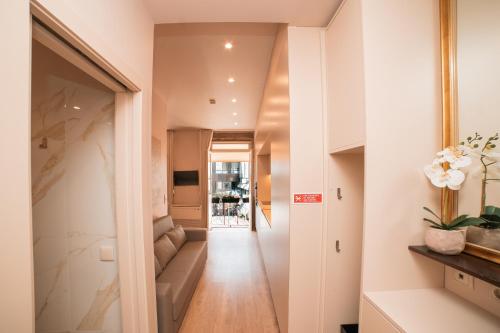 a hallway leading to a living room with a couch at Casa Monteiro by Quantique in Braga