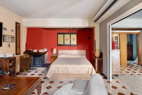 a bedroom with a bed and a red wall at Casa Vacanza il Noce in Santa Lucia di Serino