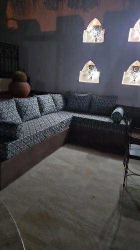a living room with a couch in a room with lights at DAR SALIA entre Agadir et Taghazout in Aourir