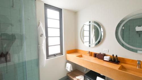 a bathroom with a sink and a mirror at Rodona Hotel in Mexico City