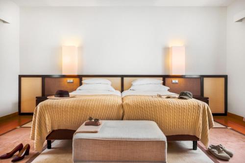 two beds in a room with two pairs of shoes at Pousada Forte da Horta in Horta