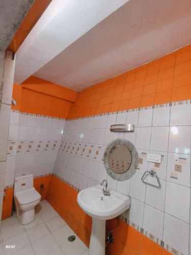 a bathroom with a sink and a toilet at Kinley Homestay in Darjeeling