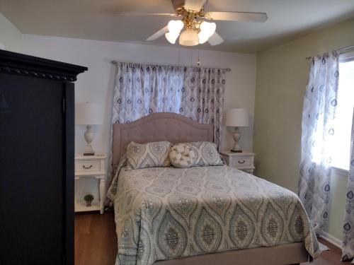 a bedroom with a bed and a ceiling fan at Sage Street Cottage in Winnsboro