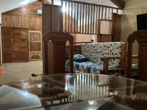 a living room with a glass table and a couch at Exotic flower cabin2 pool in Agua Bendita