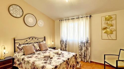 a bedroom with a bed with candles on it at LOS SAUCES DE DAIMUS - Alquiler solo a Familias in Daimuz