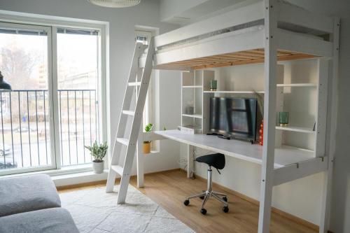 a loft bed with a desk in a room at Cosy studio in the center of Jyvaskyla in Jyväskylä