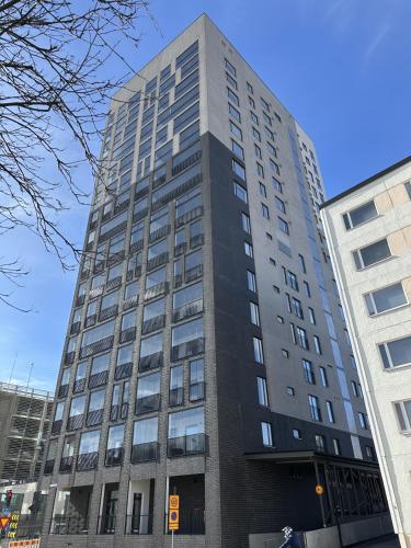 a tall gray building in a city at Cosy studio in the center of Jyvaskyla in Jyväskylä